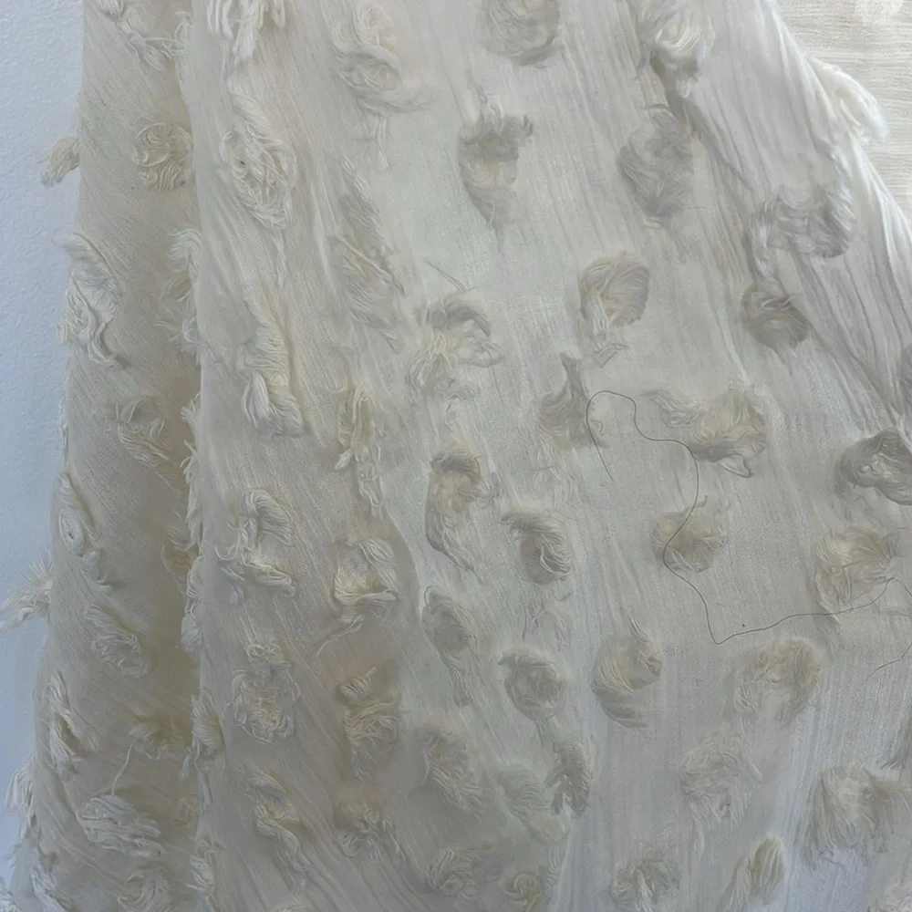 Banana Republic cream lightweight scarf or wrap with Pom Pom ball detail.